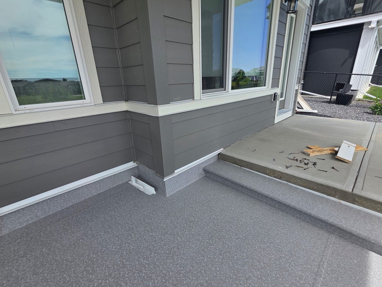 Vinyl membrane wrapped over deck steps and landing