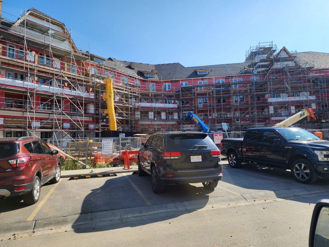 Scaffolded five-storey courtyard building at envelope stage
