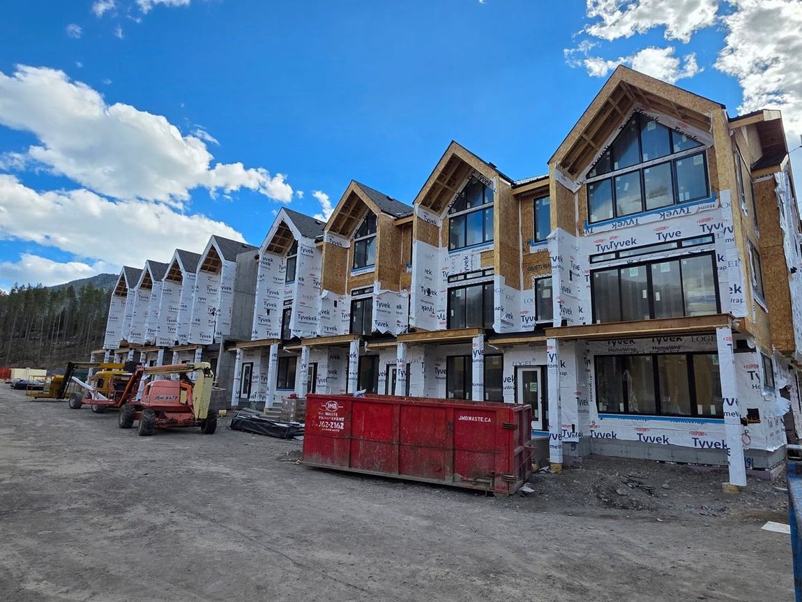 Row of wrapped chalet-style townhomes ready for membrane