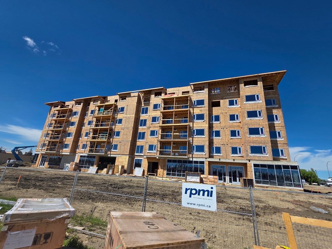 Five-storey wood-frame apartment with main-floor commercial glazing